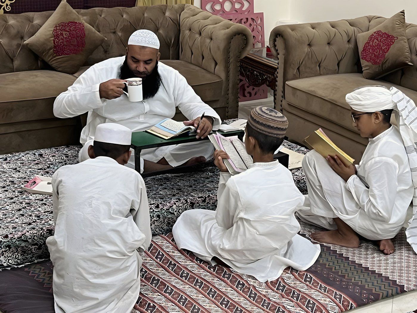 Qari Naveed Raja teaching the Quran to three young students